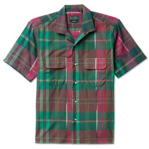 The Plum Archive Madras Camp Shirt, with short sleeves and two front pockets and white buttons on the front.