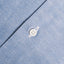 The button on the  placket on the Classic Chambray Camp Shirt.