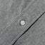 A white button on the lined placket.
