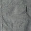 One of the flap pockets with another flap pocket on the other side of the shirt.