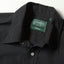 A close-up of the button free collar and a white button on the lined placket.