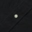 A white button on the lined placket.