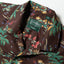 A closeup of the Brown Hawaiian Print Camp Shirt collar and the top button loop.