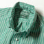 A close-up of the button down collar and a white button on the lined placket.