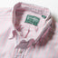 A close-up of the button down collar and a white button on the lined popover placket.