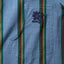 Close-up of the Nicholas Daley Rebel Riot Chambray sport shirt's hand-cut chest pocket featuring embroidered Rebel Riot detail and custom-printed stripe.