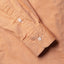 Close-up of the Orange Brushed Chambray sport shirt's lined cuff and buttons, showcasing its soft brushed chambray fabric.