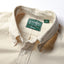 Close-up of the Ecru Silk Denim sport shirt's button-down collar featuring a lined collar and classic button detail.