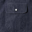 Close-up of the Indigo Silk Denim sport shirt's chest pocket, showcasing the rich indigo silk denim fabric and detailed construction.