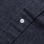 Close-up of the Indigo Silk Denim sport shirt's button placket featuring classic buttons and smooth indigo silk denim fabric.