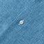  The button on the placket of the Chambray Linen Camp Shirt.