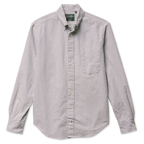 A navy striped button down shirt with a chest pocket, made from a brushed oxford fabric with white buttons.