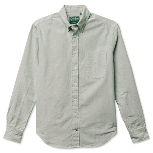 A green button down shirt with a chest pocket, made from a brushed oxford fabric with white buttons.