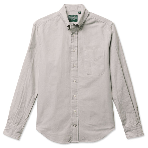 A grey button down shirt with a chest pocket, made from a brushed oxford fabric with white buttons.