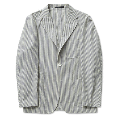 The Japanese seersucker Simple Jacket made in the USA from structured 100% cotton. Unlined and unstructured with cream and navy stripes, notch lapel, patch pockets, mother-of-pearl buttons, and an easy, polished fit.