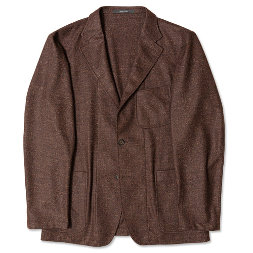 The Brown Donegal bouclé Simple Jacket made in the USA from Italian VBC merino wool. Unstructured and unlined with soft texture, patch pockets, notch lapel, horn buttons, and an easy, refined drape.