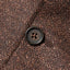 The button of the Brown Donegal bouclé Simple Jacket.