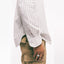 The white Striped Japanese Oxford on the body of a model showing the side drape on body.