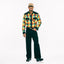 A wider angle of the Nicholas Daley Checker Madras Western
 shirt styled with lack pants and black shoes.