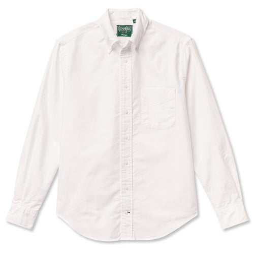 A long-sleeved, button-down  white Oxford shirt with a chest pocket, flat collar, and barrel cuffs. Gitman Vintage, 100% cotton, made in the USA.