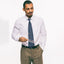 The White Pinpoint Medium Spread Oxford on body of a model showing the drape and styled with a tie.