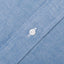 The button on the stitched placket on the Classic Chambray Short Sleeve shirt.