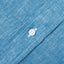 The button on the stitched placket on the Chambray Linen Short Sleeve shirt.