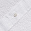 The button on the stitched placket on the White Seersucker Short Sleeve shirt.