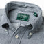 A close up of the hickory stripe denim button down collar with a green gitman vintage tag.