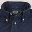 A closeup of the button down collar with white buttons and a green gitman vintage tag.