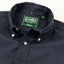 A closeup of the navy flannel collar with a button down collar and white buttons.