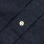 A navy flannel placket with a white button.