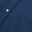 A navy-colored, button down 100% cotton Oxford shirt with a chest pocket, white button, and placket.